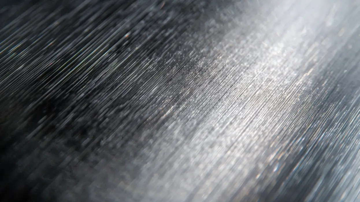 Close-up of brushed stainless steel tube surface